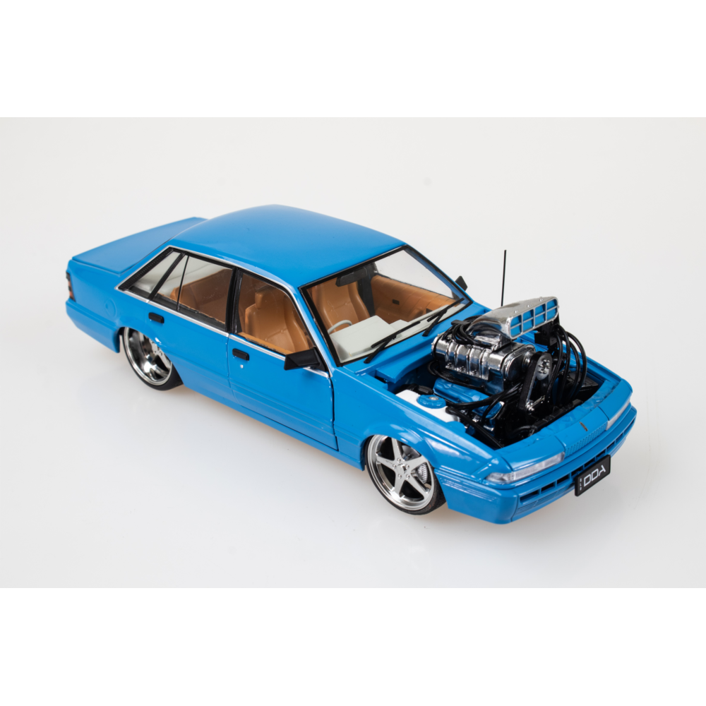 Blue Holden VL Calais Custom Supercharged 1:24 diecast, front three-quarter view with exposed engine and five-spoke wheels