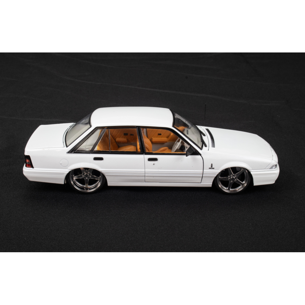 Side view of Holden VL Calais Custom 1:24 diecast with lowered stance and chrome five-spoke wheels