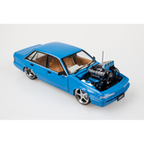 Blue Holden VL Calais Custom Supercharged 1:24 diecast, front three-quarter view with exposed engine and five-spoke wheels